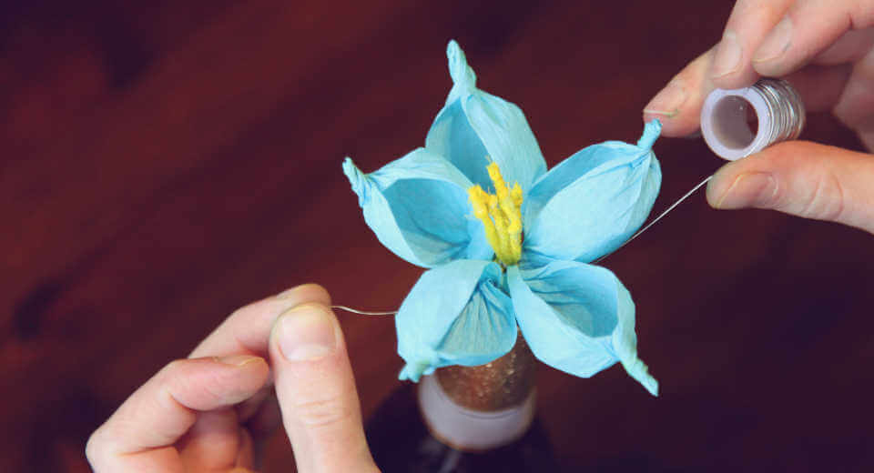 Tying the petals of the crepe flower together