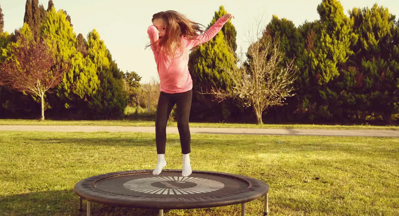 Kinderbeschäftigung draußen - Mädchen springt Trampolin