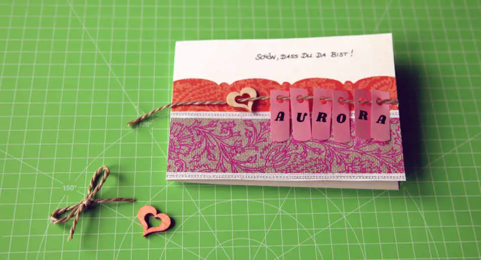 To make this birth greetings card use different papers, string and a pinch of creativity