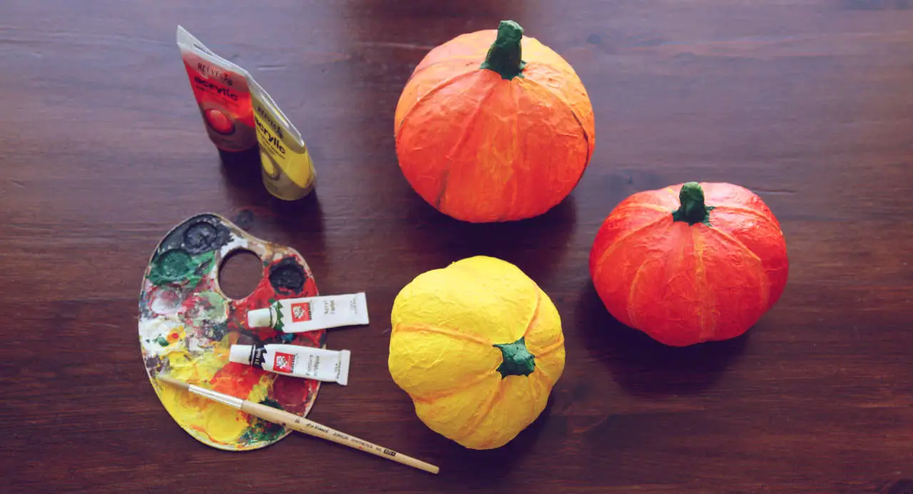 To create decorative paper mache pumpkins you can paint them with opaque acrylic paints